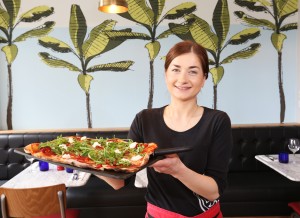 Waitress Magda Konwerska at the new look Aberdeen restaurant with some of the Winter Gardens inspired artwork in the background.